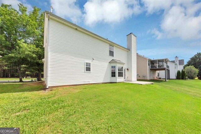 11827 Spring Lake Way, Fayetteville, GA 30215 - rear view of property with a lawn, a chimney, and a patio area