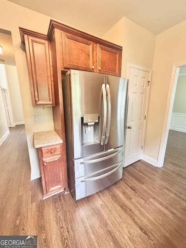 759 Hennepin Ter, Mcdonough, GA 30253 - kitchen with stainless steel refrigerator with ice dispenser, dark wood-type flooring, brown cabinets, and baseboards