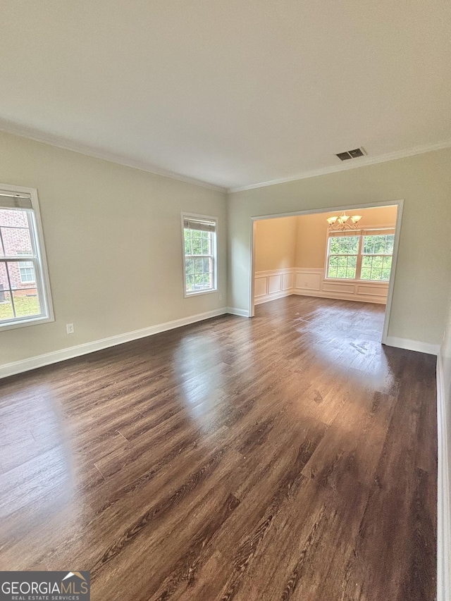 759 Hennepin Ter, Mcdonough, GA 30253 - empty room with a chandelier, crown molding, dark wood-style floors, and baseboards