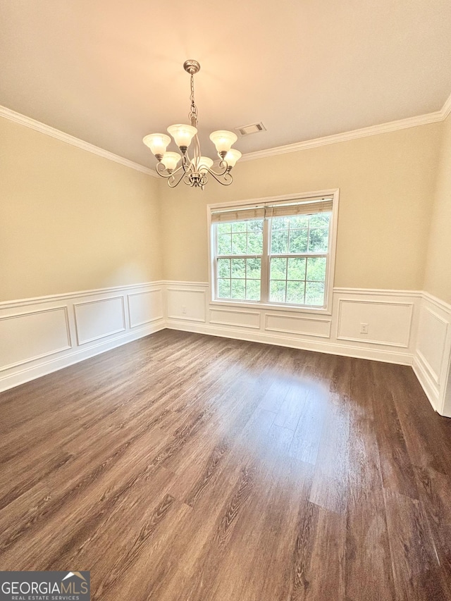 759 Hennepin Ter, Mcdonough, GA 30253 - empty room featuring a chandelier, crown molding, dark wood-style floors, and a wainscoted wall