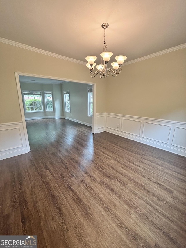 759 Hennepin Ter, Mcdonough, GA 30253 - spare room featuring a chandelier, crown molding, dark wood finished floors, wainscoting, and a decorative wall
