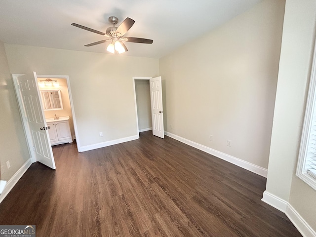 759 Hennepin Ter, Mcdonough, GA 30253 - unfurnished bedroom featuring dark wood-style flooring, baseboards, ensuite bathroom, and a sink