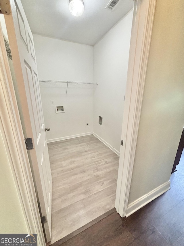 759 Hennepin Ter, Mcdonough, GA 30253 - laundry area featuring wood finished floors, washer hookup, hookup for an electric dryer, and baseboards