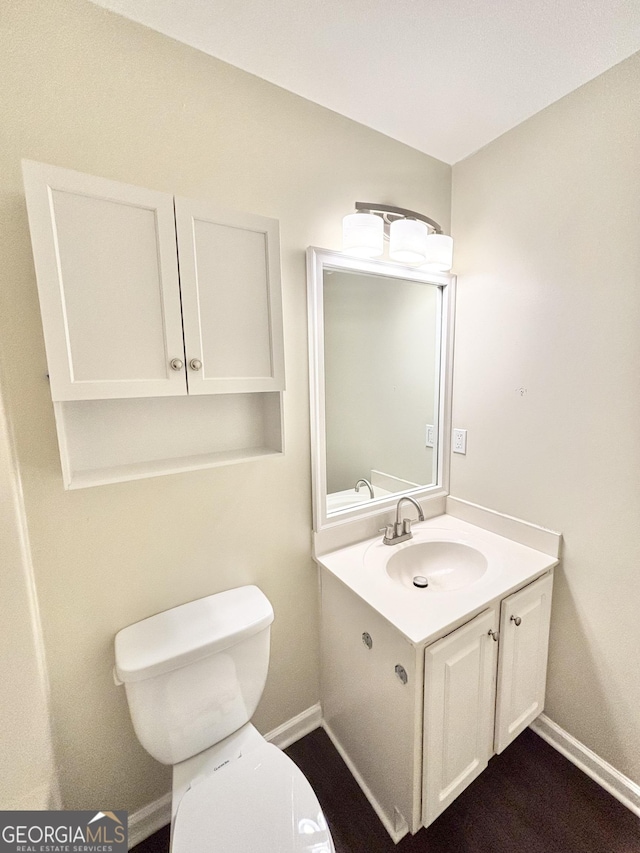 759 Hennepin Ter, Mcdonough, GA 30253 - bathroom featuring toilet, vanity, and baseboards