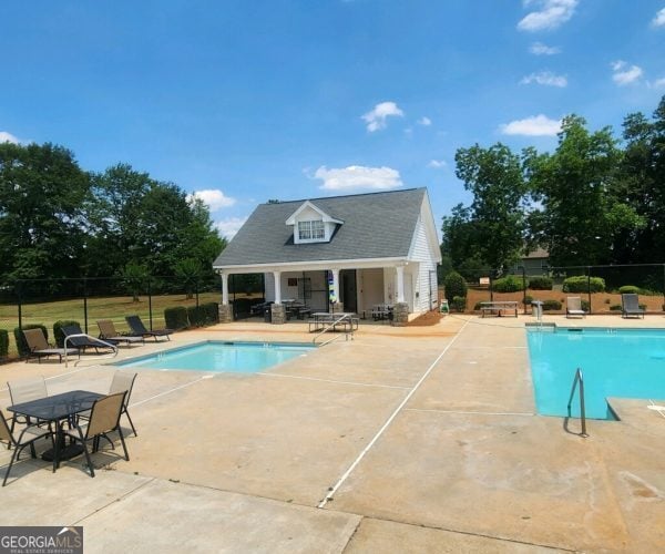 759 Hennepin Ter, Mcdonough, GA 30253 - community pool with a patio area, an outbuilding, and an exterior structure