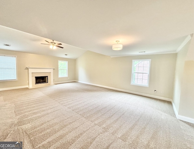 759 Hennepin Ter, Mcdonough, GA 30253 - unfurnished living room featuring baseboards, carpet floors, a ceiling fan, a fireplace, and crown molding