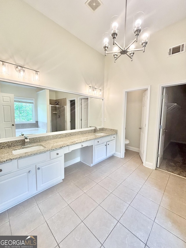 759 Hennepin Ter, Mcdonough, GA 30253 - bathroom featuring tile patterned flooring, a chandelier, double vanity, a shower stall, and toilet