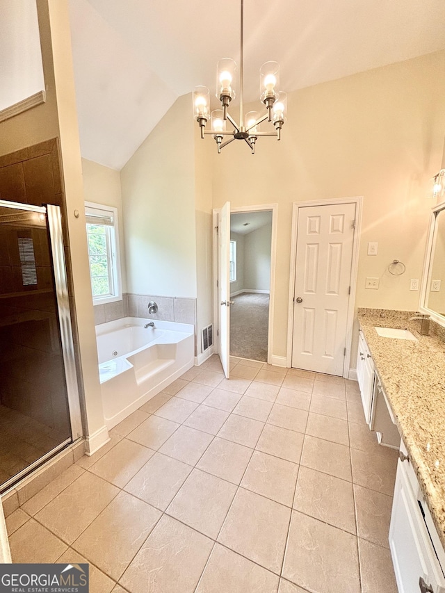 759 Hennepin Ter, Mcdonough, GA 30253 - bathroom featuring a chandelier, tile patterned floors, a bath, vanity, and lofted ceiling