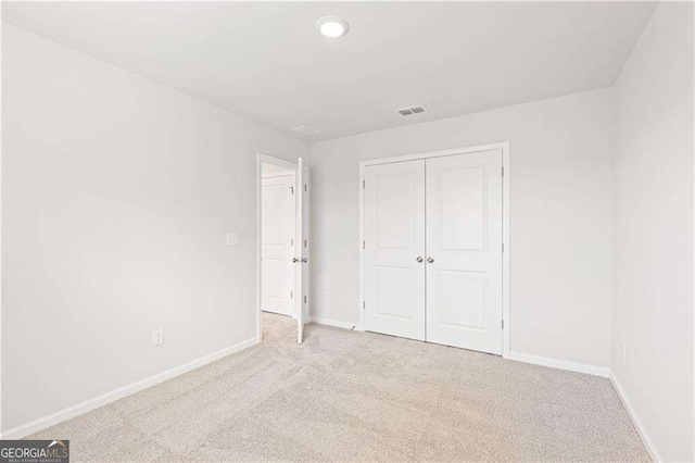 7193 Brushwood Bnd, Lithonia, GA 30058 - unfurnished bedroom with carpet flooring, baseboards, a closet, and recessed lighting