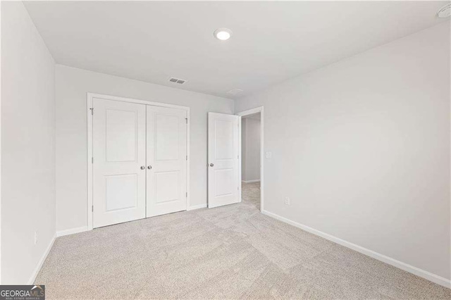 7193 Brushwood Bnd, Lithonia, GA 30058 - unfurnished bedroom featuring baseboards, carpet floors, a closet, and recessed lighting
