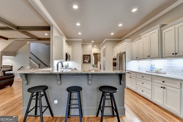 3715 Horizon Ct, Cumming, GA 30041 - kitchen with ornamental molding, a breakfast bar area, recessed lighting, white cabinetry, and decorative backsplash