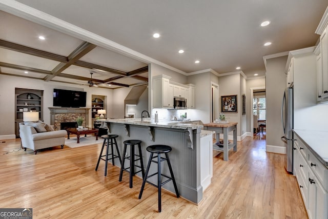 3715 Horizon Ct, Cumming, GA 30041 - kitchen featuring stainless steel appliances, a ceiling fan, a breakfast bar, light stone countertops, and recessed lighting