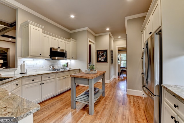 3715 Horizon Ct, Cumming, GA 30041 - kitchen with appliances with stainless steel finishes, backsplash, crown molding, white cabinetry, and recessed lighting