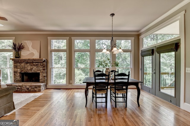 3715 Horizon Ct, Cumming, GA 30041 - dining room with crown molding, healthy amount of natural light, light wood-style floors, and a stone fireplace