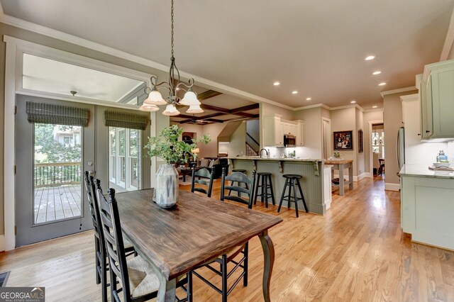 3715 Horizon Ct, Cumming, GA 30041 - dining space featuring healthy amount of natural light, recessed lighting, a chandelier, ornamental molding, and light wood finished floors