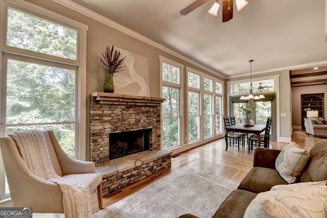 3715 Horizon Ct, Cumming, GA 30041 - living room featuring a fireplace, ornamental molding, a chandelier, a ceiling fan, and wood finished floors