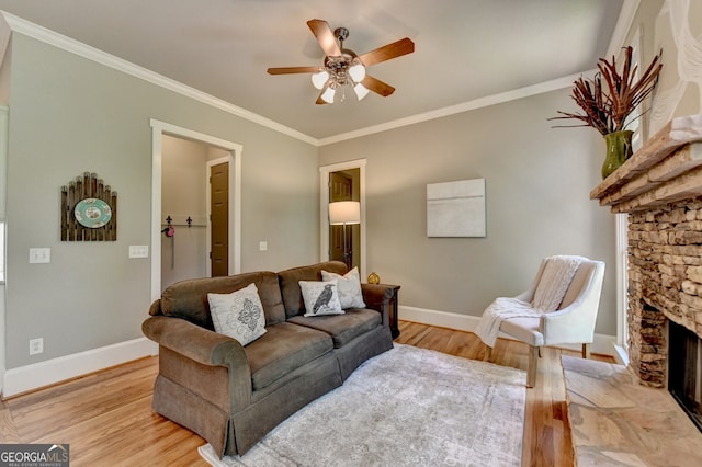 3715 Horizon Ct, Cumming, GA 30041 - living room with a ceiling fan, light wood-style floors, a stone fireplace, and crown molding