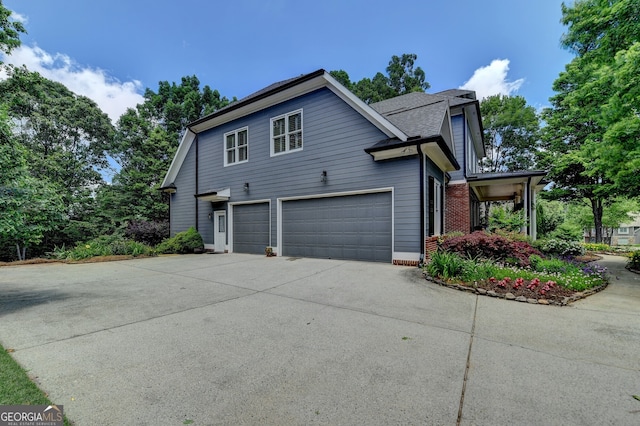 3715 Horizon Ct, Cumming, GA 30041 - view of side of home featuring concrete driveway, an attached garage, brick siding, and a shingled roof