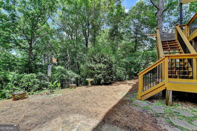 3715 Horizon Ct, Cumming, GA 30041 - view of yard with stairs, a wooden deck, and view of scattered trees