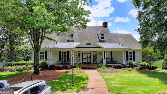 3715 Horizon Ct, Cumming, GA 30041 - cape cod home featuring a porch, a front yard, a standing seam roof, and a chimney