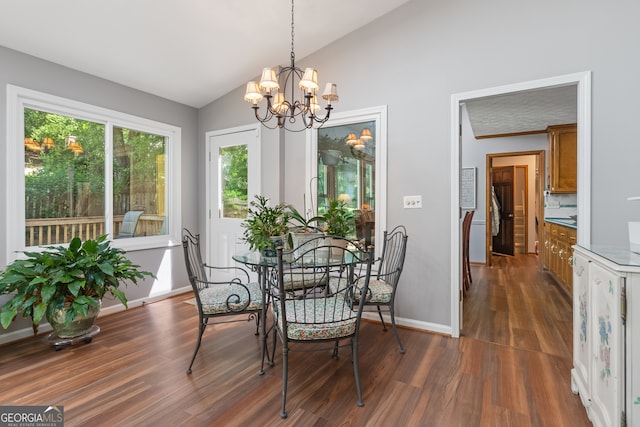 1850 Linnet Ct NE, Roswell, GA 30075 - dining room with lofted ceiling, a chandelier, dark wood-style flooring, and baseboards