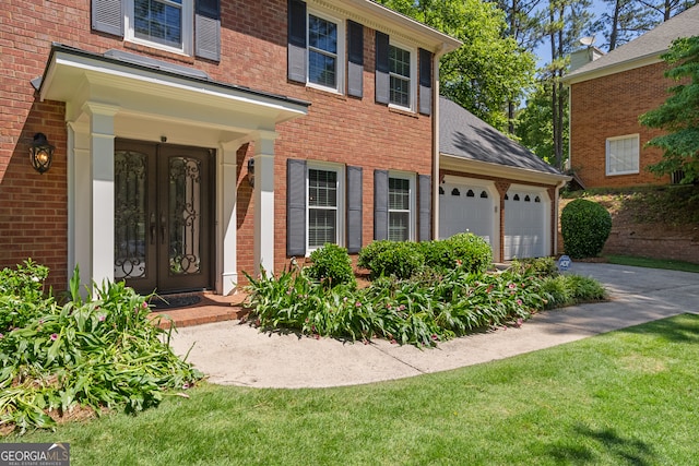 1850 Linnet Ct NE, Roswell, GA 30075 - view of exterior entry featuring brick siding, driveway, a garage, and a shingled roof