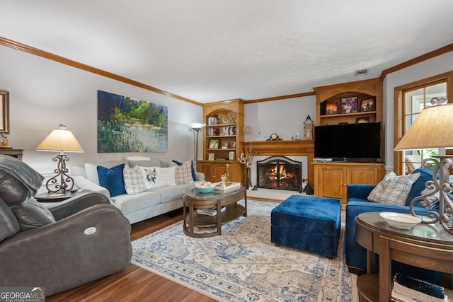1850 Linnet Ct NE, Roswell, GA 30075 - living area with wood finished floors, ornamental molding, a warm lit fireplace, and built in shelves