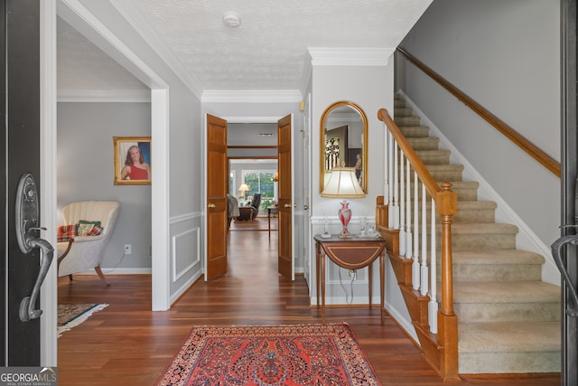 1850 Linnet Ct NE, Roswell, GA 30075 - entrance foyer with dark wood-style flooring, stairs, ornamental molding, a textured ceiling, and baseboards