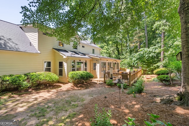1850 Linnet Ct NE, Roswell, GA 30075 - back of property featuring a wooden deck, roof with shingles, and a standing seam roof