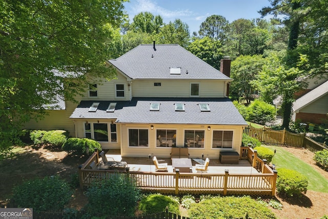 1850 Linnet Ct NE, Roswell, GA 30075 - rear view of house featuring an outdoor living space, a wooden deck, a chimney, and a shingled roof
