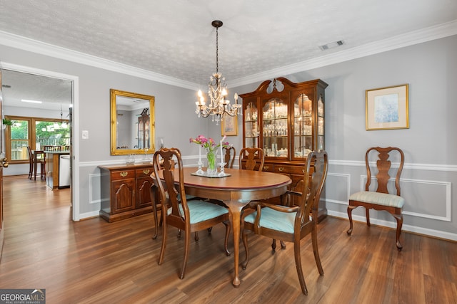 1850 Linnet Ct NE, Roswell, GA 30075 - dining area with dark wood-style floors, a chandelier, a textured ceiling, a wainscoted wall, and crown molding