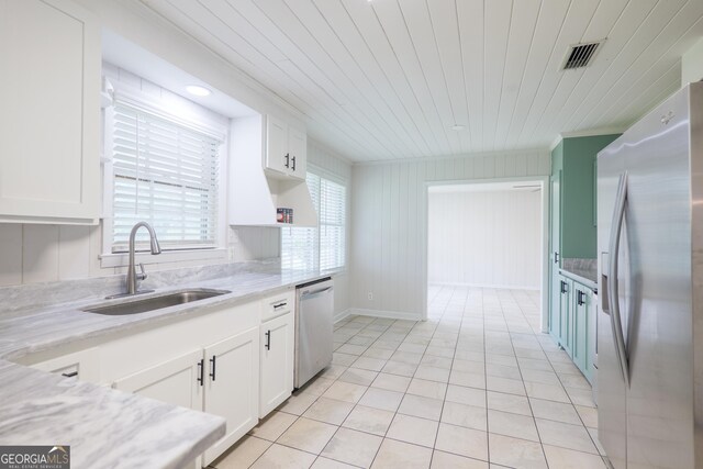 215 E Main St, Hahira, GA 31632 - kitchen with stainless steel appliances, a sink, white cabinets, light tile patterned flooring, and wood ceiling