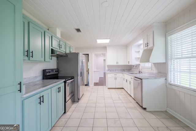 215 E Main St, Hahira, GA 31632 - kitchen featuring stainless steel appliances, under cabinet range hood, light countertops, light tile patterned flooring, and a sink