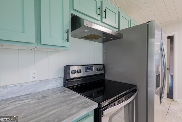 215 E Main St, Hahira, GA 31632 - kitchen with electric range, under cabinet range hood, green cabinetry, and light countertops