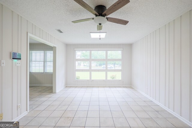 215 E Main St, Hahira, GA 31632 - unfurnished room with a textured ceiling, ceiling fan, light tile patterned flooring, and baseboards