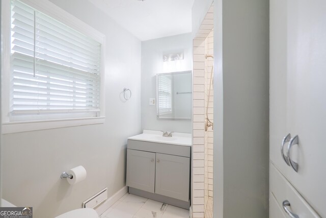 215 E Main St, Hahira, GA 31632 - bathroom with marble finish floors, vanity, toilet, and baseboards