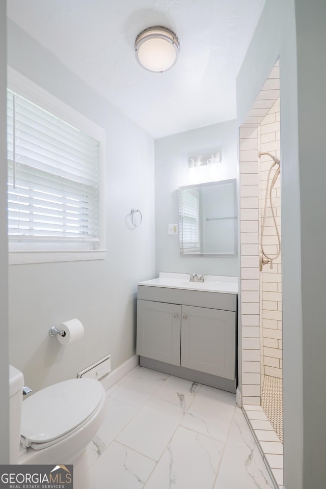 215 E Main St, Hahira, GA 31632 - full bath featuring tiled shower, toilet, vanity, and marble look tile flooring
