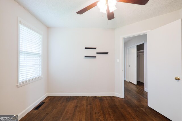 215 E Main St, Hahira, GA 31632 - unfurnished room featuring ceiling fan, dark wood-style flooring, and baseboards