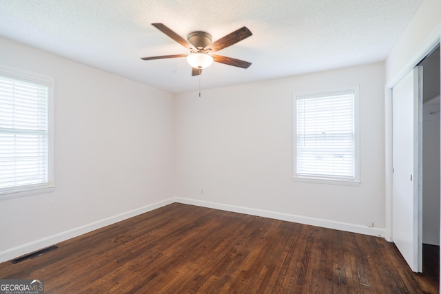 215 E Main St, Hahira, GA 31632 - unfurnished bedroom with dark wood-style flooring, a closet, baseboards, and ceiling fan