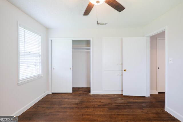 215 E Main St, Hahira, GA 31632 - unfurnished bedroom featuring dark wood-style floors, a closet, baseboards, and a ceiling fan