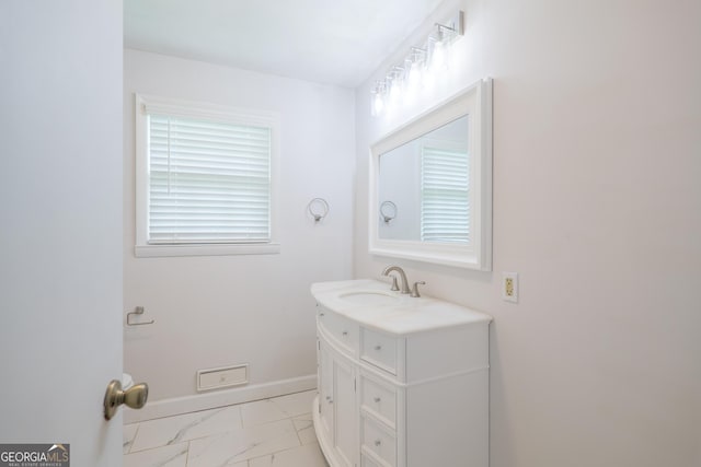 215 E Main St, Hahira, GA 31632 - bathroom with marble look tile flooring, vanity, and baseboards