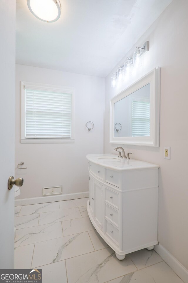 215 E Main St, Hahira, GA 31632 - bathroom featuring marble finish flooring, vanity, and baseboards