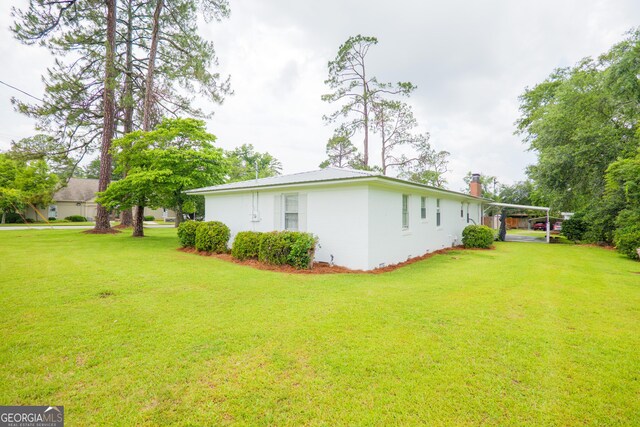 215 E Main St, Hahira, GA 31632 - view of grassy yard with a carport