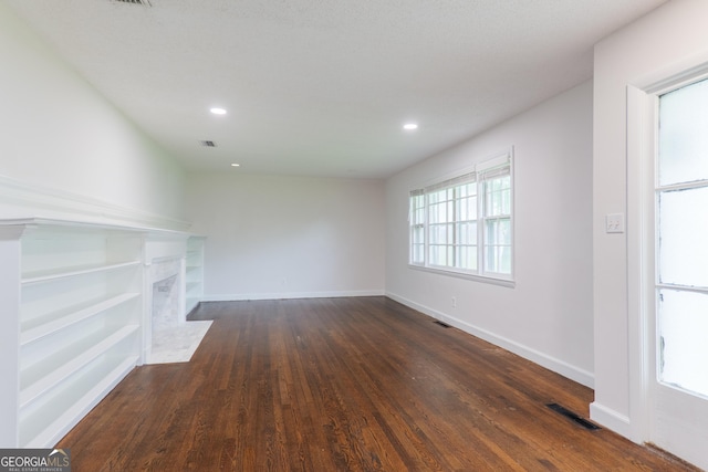 215 E Main St, Hahira, GA 31632 - unfurnished living room featuring dark wood-style floors, recessed lighting, baseboards, and a premium fireplace