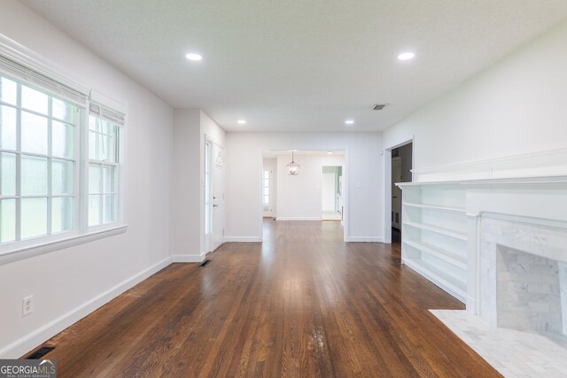 215 E Main St, Hahira, GA 31632 - unfurnished living room featuring dark wood-style flooring, recessed lighting, baseboards, and a premium fireplace