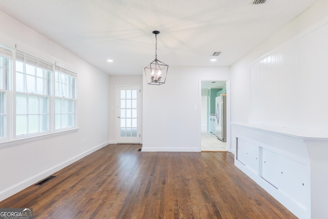 215 E Main St, Hahira, GA 31632 - unfurnished dining area with baseboards, a chandelier, and dark wood-style floors
