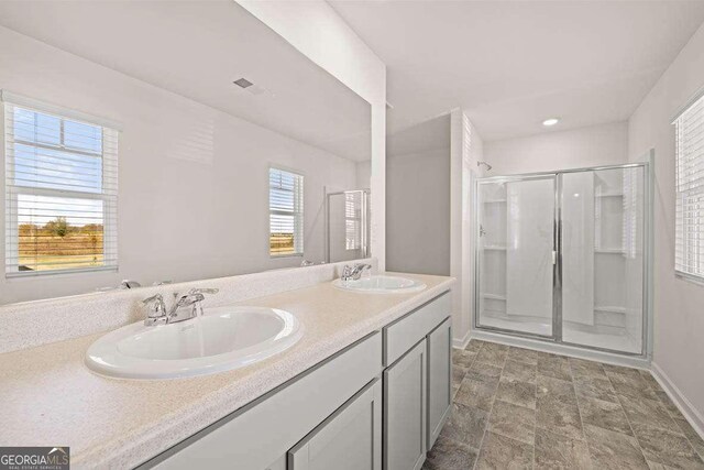 173 Aster Ave, Locust Grove, GA 30248 - full bath featuring a shower stall, double vanity, baseboards, stone finish floors, and recessed lighting