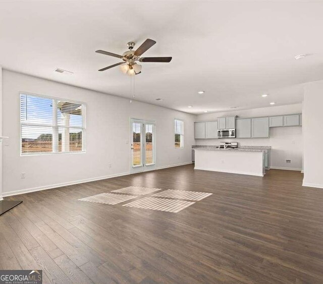 173 Aster Ave, Locust Grove, GA 30248 - unfurnished living room with a ceiling fan, dark wood finished floors, baseboards, and recessed lighting