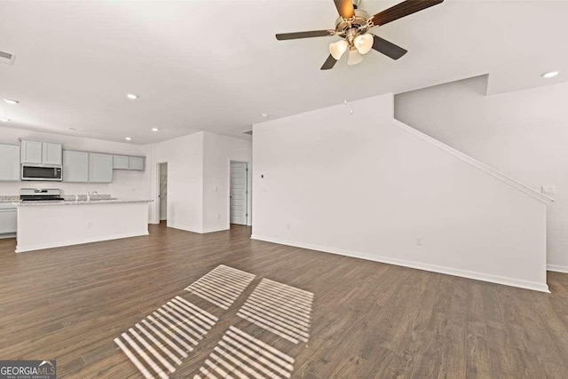173 Aster Ave, Locust Grove, GA 30248 - unfurnished living room with a ceiling fan, dark wood finished floors, baseboards, recessed lighting, and a sink