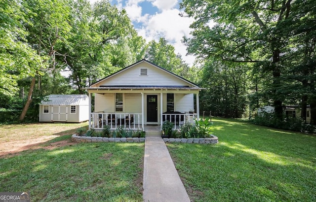 430 Sherwood Cir, Danielsville, GA 30633 - bungalow-style house featuring a porch, a shed, a front lawn, and view of wooded area